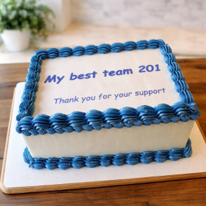 A rectangular cake with blue icing borders and text reading My best team 201 Thank you for your support on a wooden table.